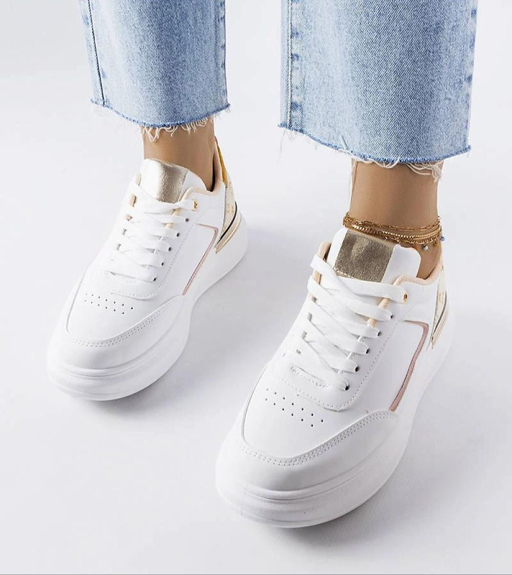 Person wearing Marriale white sneakers with beige detail and lace-up front, paired with blue jeans, showcasing modern summer fashion.