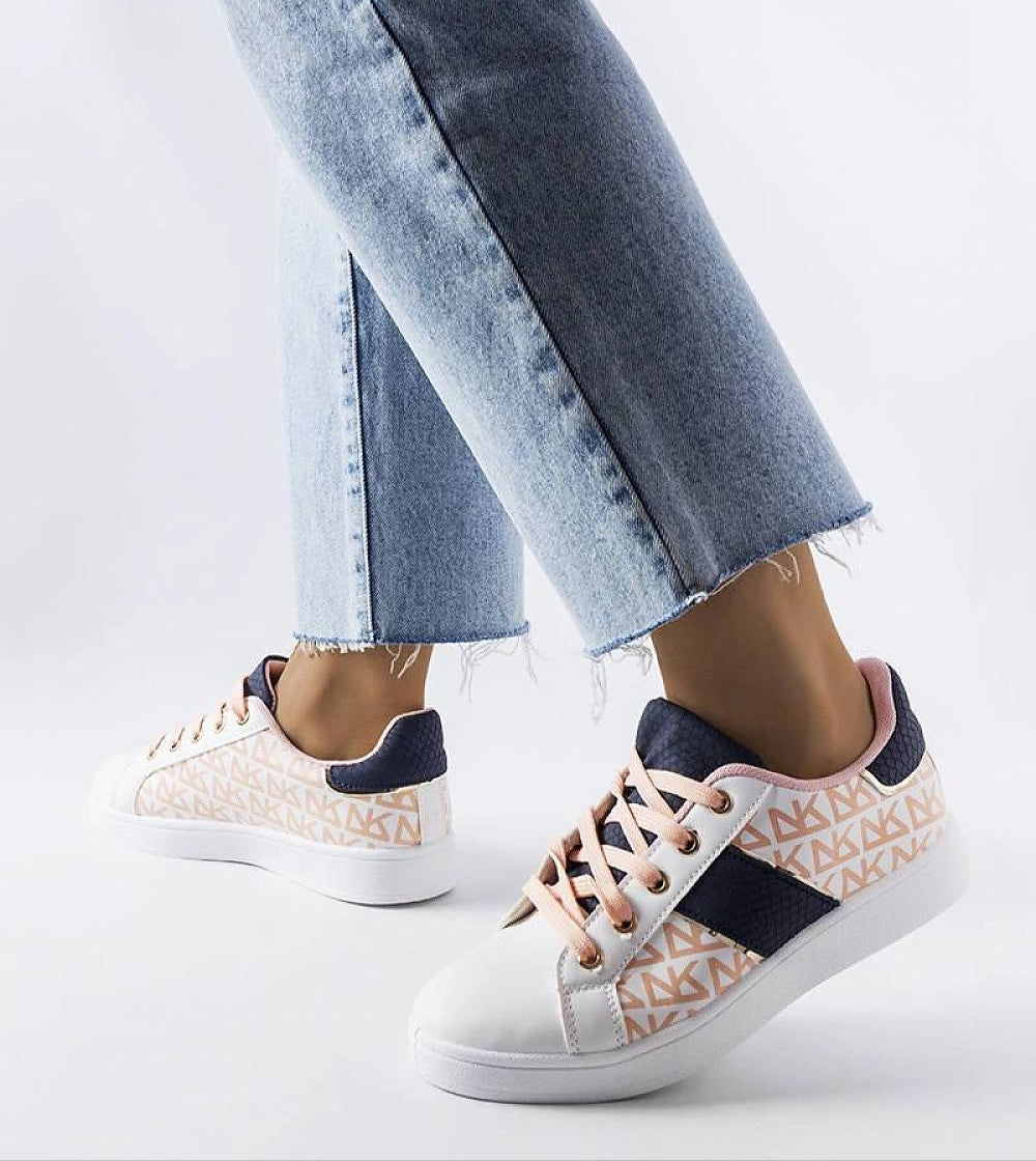 Woman wearing Alelya Doringer StrideGlow Sneakers in white with colorful accents, paired with light blue jeans.