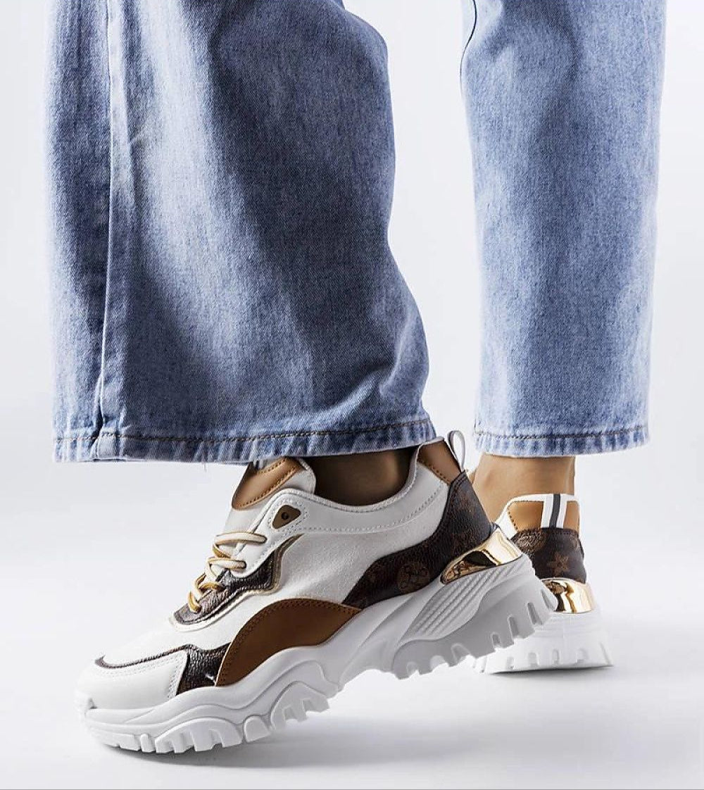 Person wearing Altorra Irregular Sole White Sneakers with jeans, showcasing modern design featuring a sculptural sole and minimalist flair.