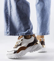 Person wearing Altorra Irregular Sole White Sneakers with jeans, showcasing modern design featuring a sculptural sole and minimalist flair.