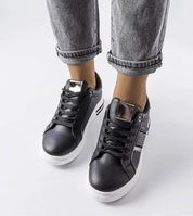 Woman wearing Meralla Rhinestone Platform Sneakers with black laces and jeans, showcasing the glittering details and 4 cm white sole.