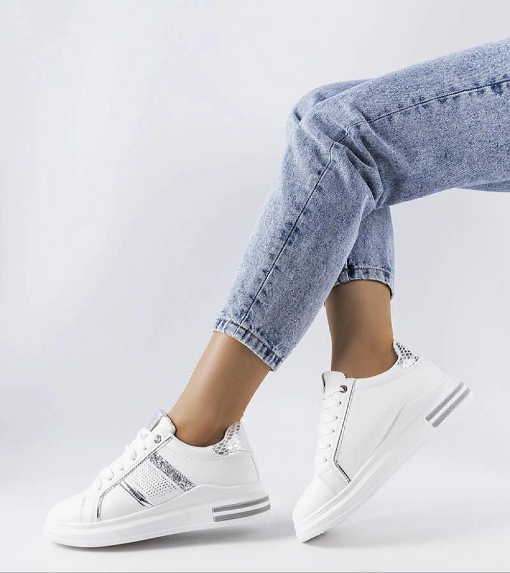 Meralla Rhinestone Platform Sneakers in beige with shimmering rhinestone details, worn by a model in jeans, showcasing sporty elegance.