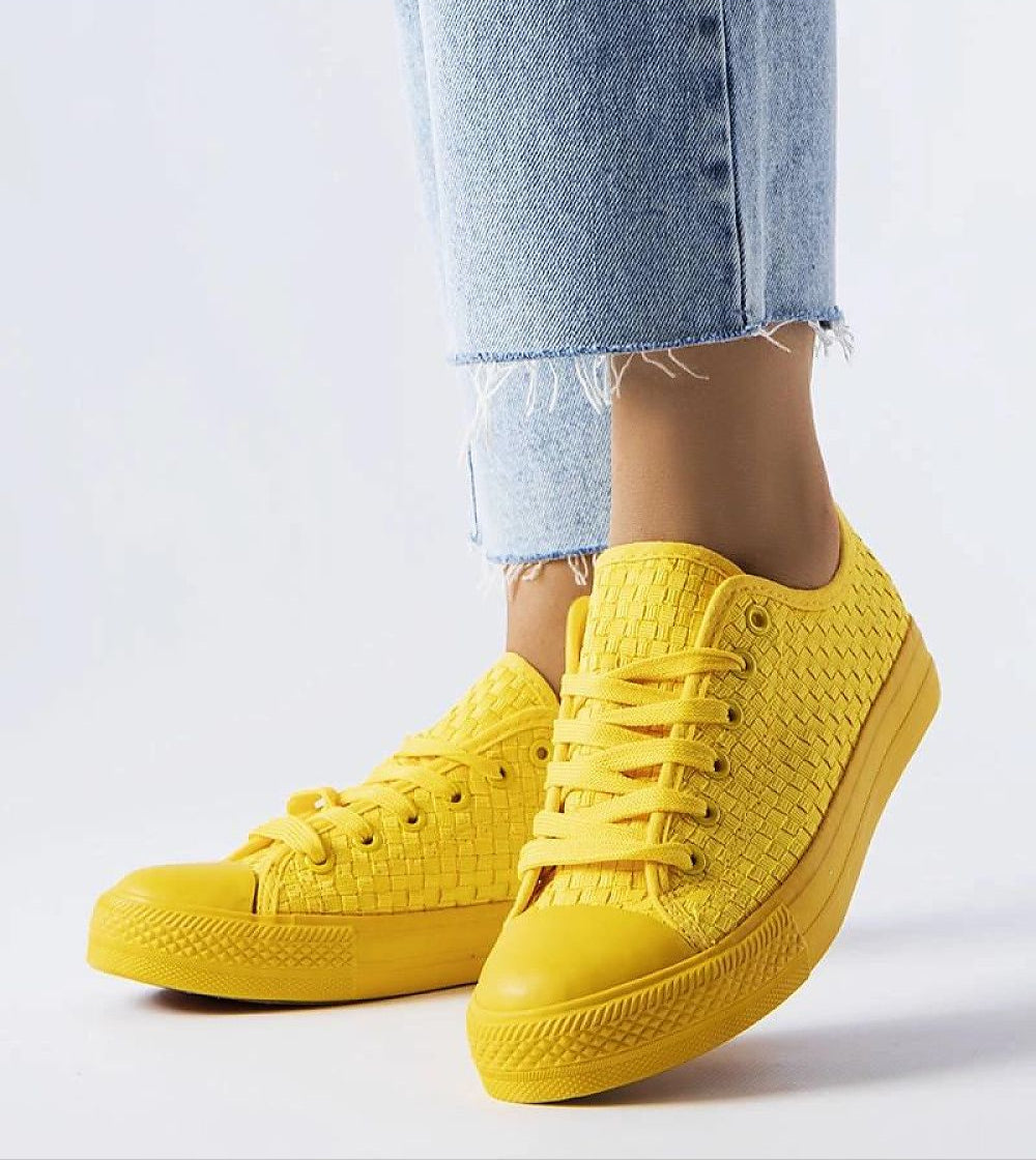 Yellow Revarya Woven Lace-Up Summer Sneakers with blue jeans, showcasing breathable upper and flexible rubber sole for comfort.