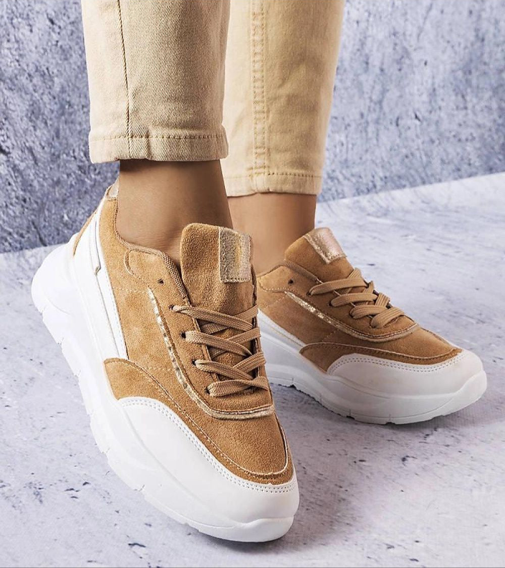 Woman wearing Ismerra suede platform lace sneakers with eco suede upper and sculpted sole, showcasing elegant and comfortable style.