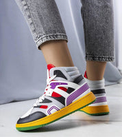 Person wearing colorful Dervina Classic High-Top Sneakers with eco leather and 3 cm rubber sole on white floor.