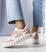 Elvenza Grooved Sole Ankle Sneakers with platform sole and bold stitching in pink and white, paired with blue jeans.