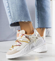 Person wearing Yllendra mixed texture platform sneakers in denim jeans, showcasing eco leather and layered design with 5 cm rubber sole.