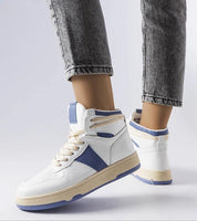 Woman wearing Ormelya High-Top Everyday Sneakers in eco leather with blue accents, showcasing the stylish and comfortable design.