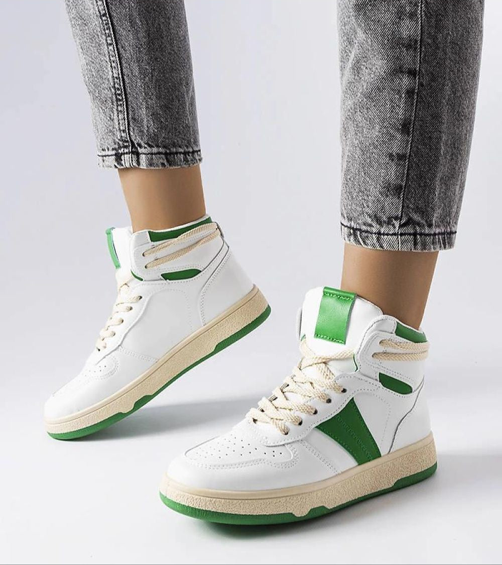 Woman wearing Ormelya High-Top Everyday Sneakers in white and green, featuring a clean silhouette and supportive eco-friendly leather design.
