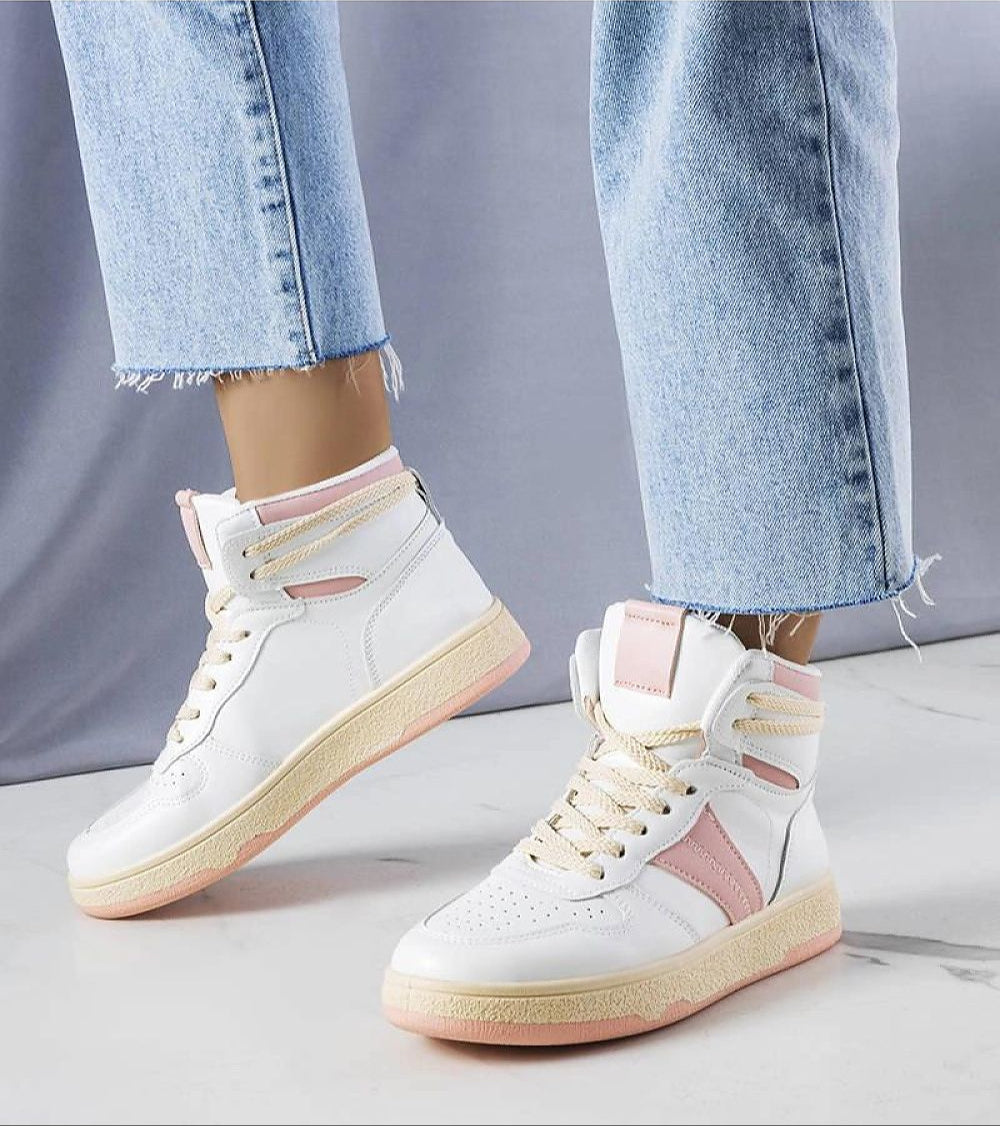 Person wearing Ormelya high-top everyday sneakers in white and pink with blue jeans, showcasing eco leather upper and 3 cm sole.