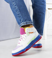 Colorful high-top sneakers with a lace-up design and vibrant sole, paired with denim jeans, perfect for casual wear.