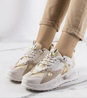Beige and white platform sneakers with eco leather upper and 4.5 cm sole, worn with cuffed pants on a marble floor.