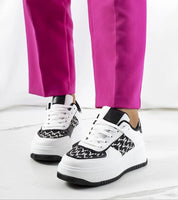 Myrelith Lifted Sole Lace Sneakers with eco leather upper and elevated sole, showcased with vibrant pink pants.