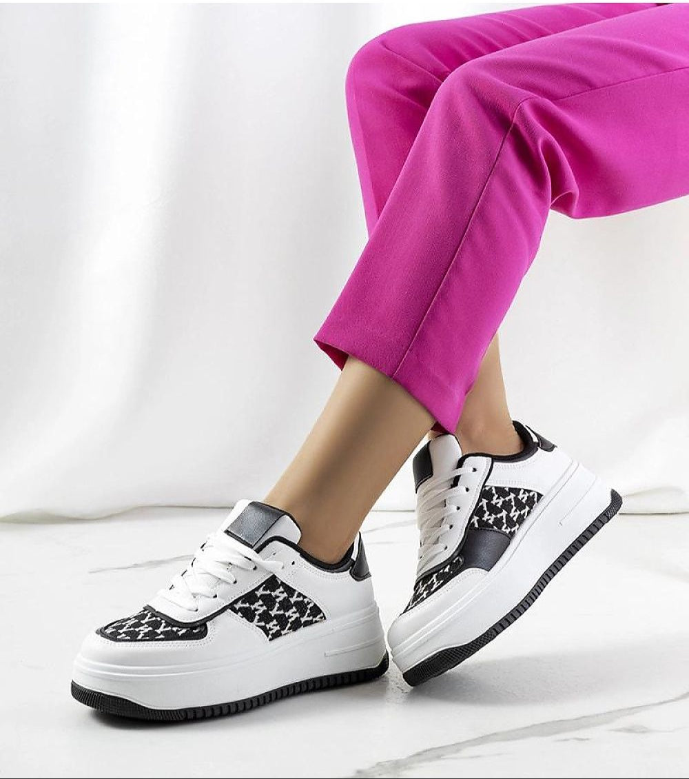 Person wearing Myrelith Lifted Sole Lace Sneakers in eco leather with pink pants, showcasing elevated sole and classic design.
