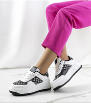 Person wearing Myrelith Lifted Sole Lace Sneakers in eco leather with pink pants, showcasing elevated sole and classic design.