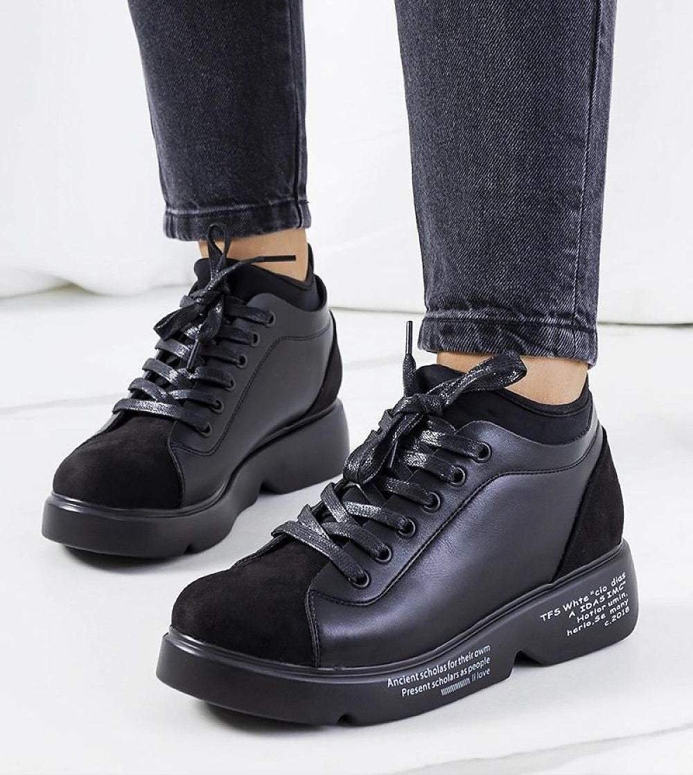 Sleek black Odyrelle contour platform sneakers with lace-up design and eco leather finish, highlighting sculptural base and structured sole.