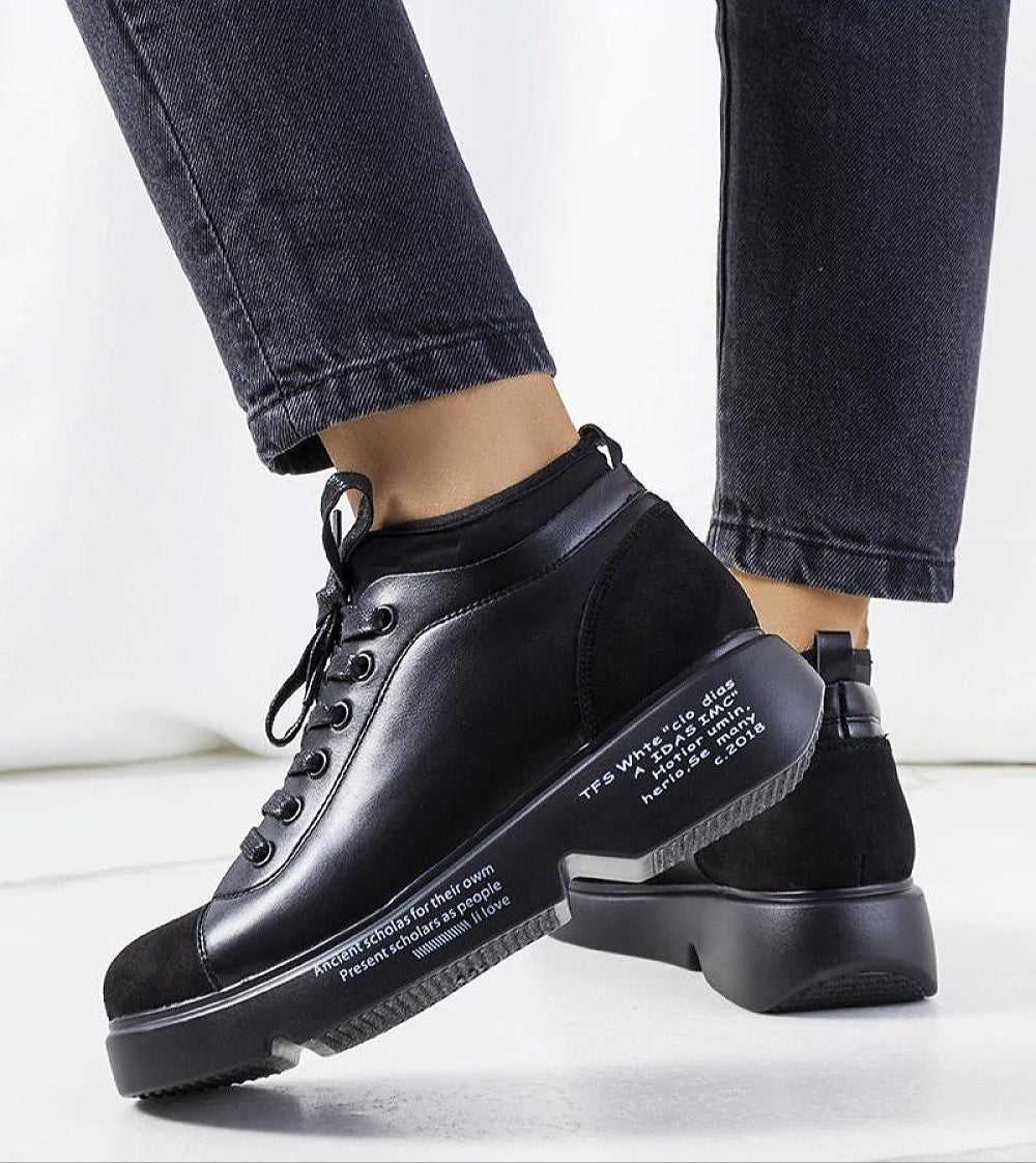 Odyrelle Contour Platform Sneakers in black eco leather with a structured sole, shown on a person wearing black jeans.