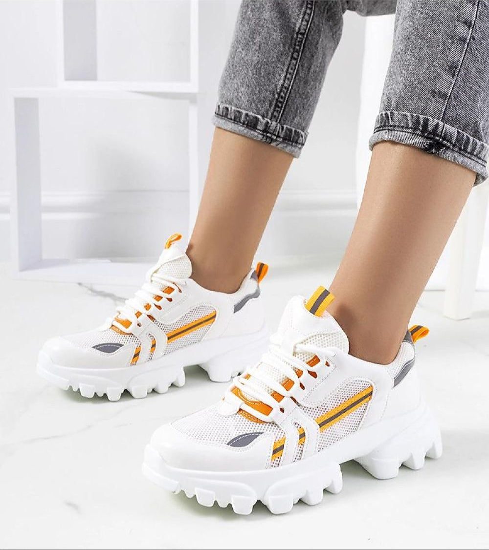 Woman wearing Seralyne Reflective Trim Platform Sneakers with eco leather upper and 4.5 cm platform, featuring reflective accents.