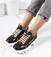 Seralyne reflective trim platform sneakers with eco leather upper, rubber soles, and lace-up closure for a sporty look on white background.