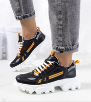 Seralyne Reflective Trim Platform Sneakers with orange accents and thick white soles, featuring eco leather uppers and lace-up closure.