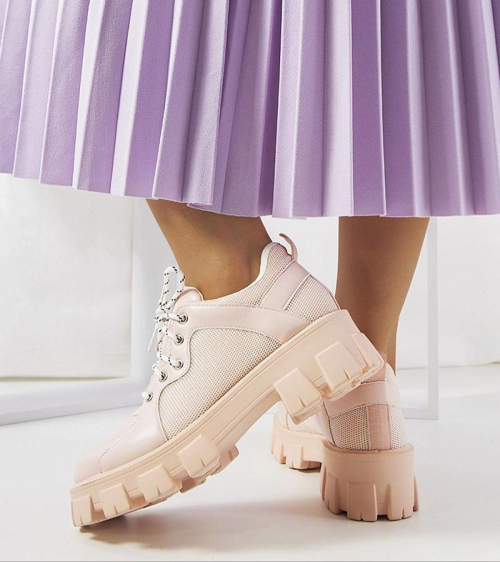 Person wearing Aurenza Daywalk Platform Sneakers with a purple pleated skirt.