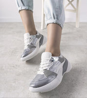 Zelphira Metallic Contrast Platform Sneakers with silver eco leather, high white sole, and lace-up closure on a grey floor.