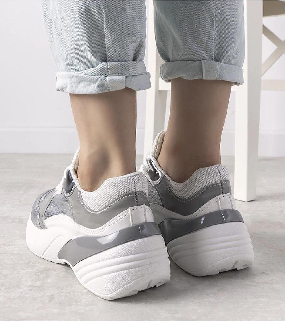 Back view of Zelphira Metallic Contrast Platform Sneakers with high white sole and silver eco leather, worn with rolled-up jeans.