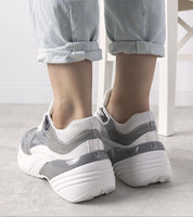 Back view of Zelphira Metallic Contrast Platform Sneakers with high white sole and silver eco leather, worn with rolled-up jeans.