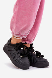 Person wearing Cernia Synthetic Platform Lace Sneakers in black with pink joggers, highlighting streetwear style and comfort.