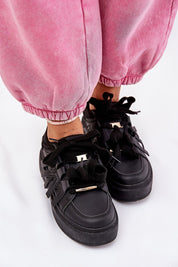 Person wearing Cernia Synthetic Platform Lace Sneakers in black with pink pants, highlighting the structured design and platform sole.