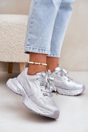 Woman wearing glittered Ravelline platform sneakers with zircon embellishments and cushioned sole, perfect for adding glamour to casual wear.