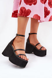 Arlona Echo Wedge Sandals with eco leather straps and adjustable ankle strap, worn with a floral skirt for a chic summer look.
