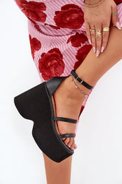 Black Arlona Echo wedge sandal with eco leather straps and adjustable ankle strap, worn with floral skirt.
