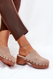 Woman wearing Corveda Studded Suede Wedge Clogs with bohemian charm and eco leather insole for comfort and style.
