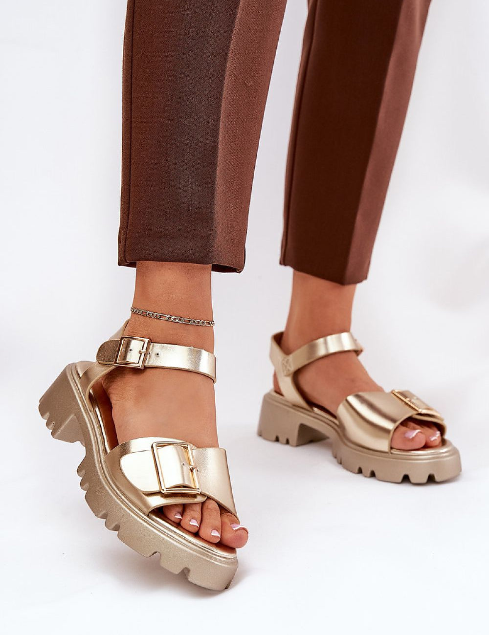 Talmera Buckled Platform Sandals with gold buckle and eco leather finish, worn with brown trousers, perfect for warm weather styling.