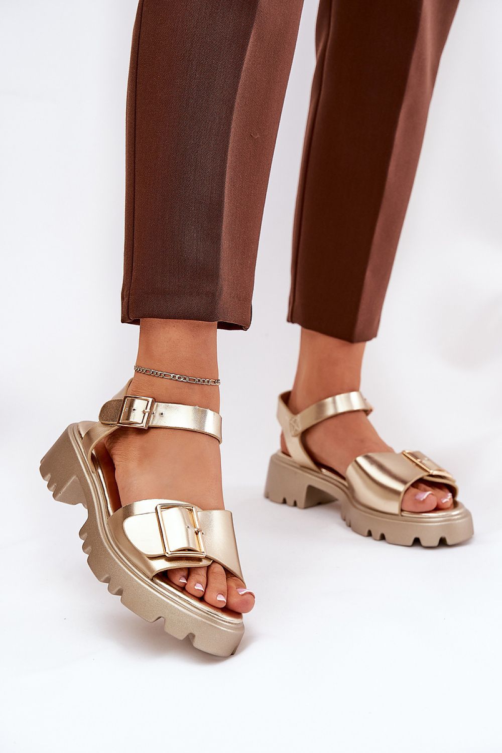 Talmera Buckled Platform Sandals with gold buckle and eco leather finish, worn with brown trousers, perfect for warm weather styling.