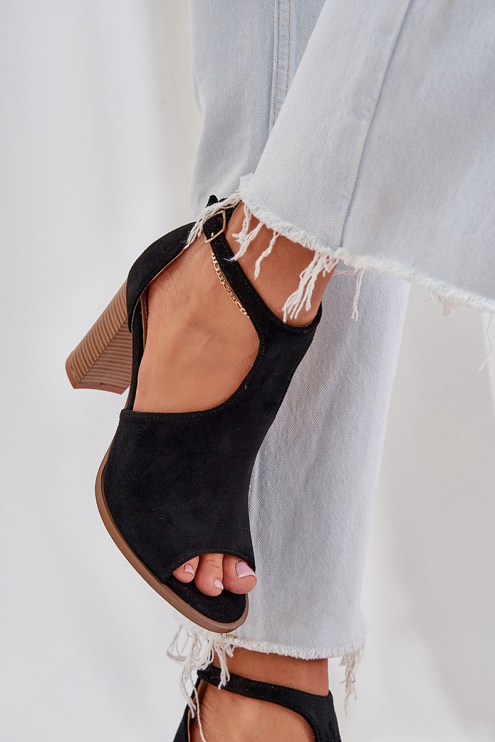 Elanvera Suede Buckled Heel Sandals in black eco-suede with adjustable ankle strap, shown with frayed hem denim jeans.