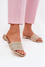 Arelia Flat Summer Slides featuring breathable textile upper and eco-leather insole, perfectly paired with pink pants for warm days.