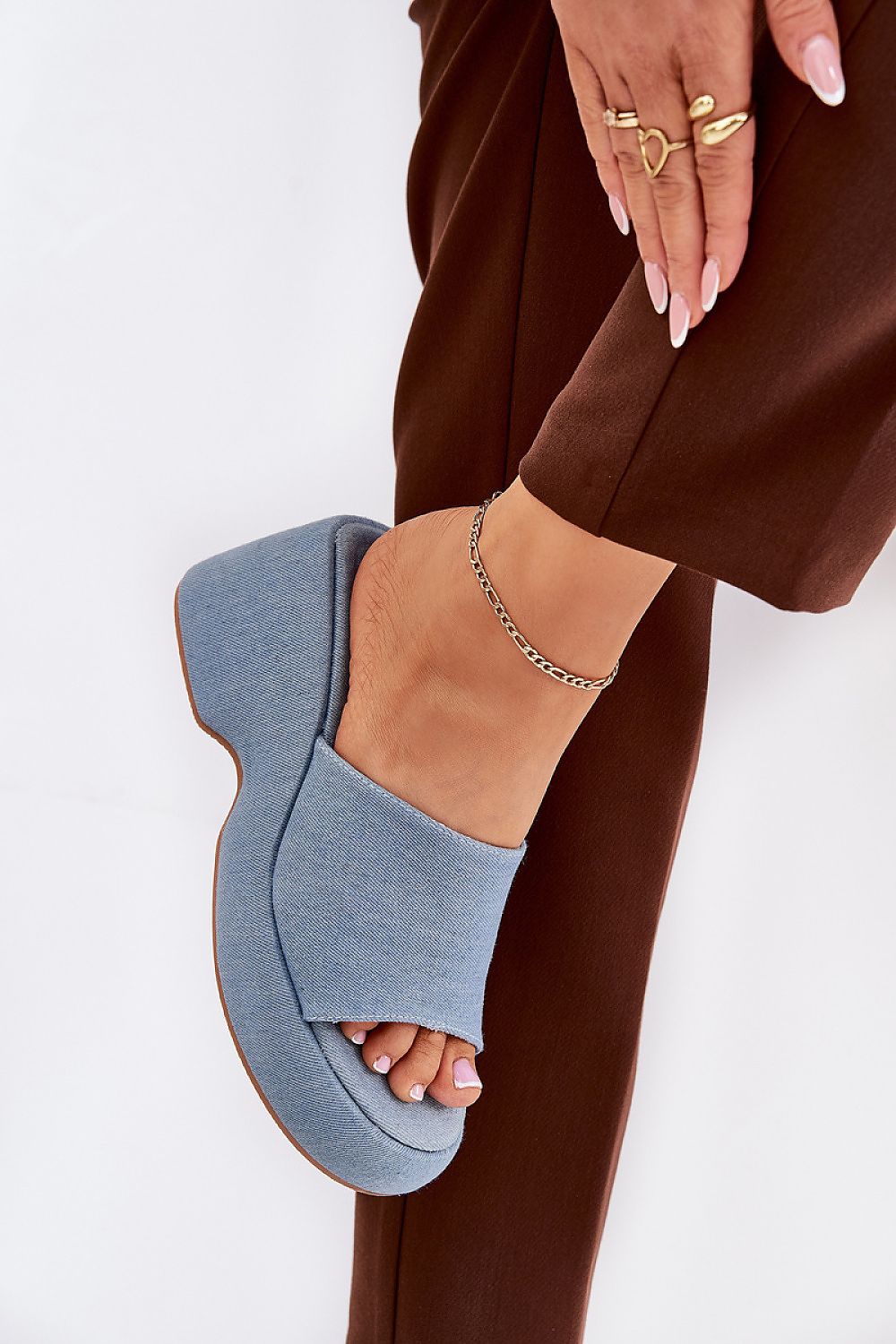 Blue textile wedge sandals with open-toe design and high platform, showcasing a woven texture and suede-like finish for summer style.