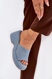 Blue textile wedge sandals with open-toe design and high platform, showcasing a woven texture and suede-like finish for summer style.