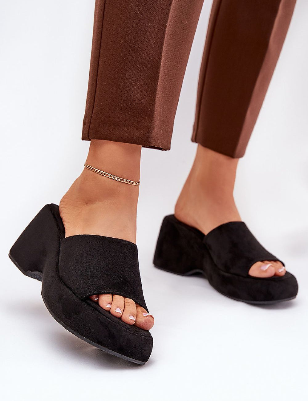 Woman wearing Zalhera Elevated Textile Wedge Sandals in black with suede-like finish, open-toe style and high platform.