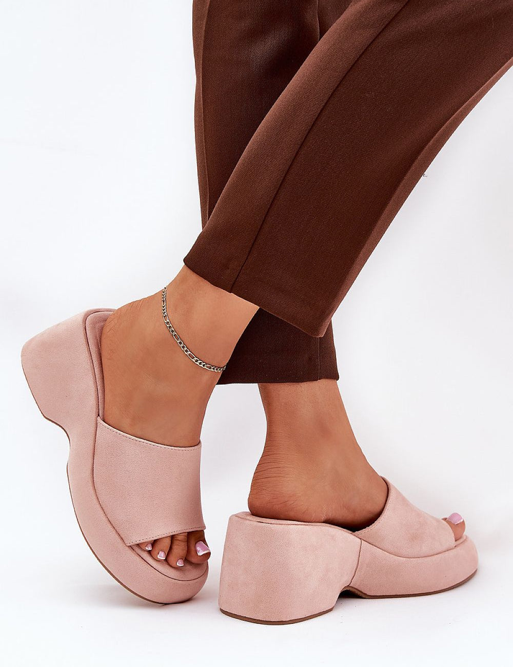 Open-toe wedge sandals with pink suede-like textile, elevated platform, and modern design, perfect for stylish summer outings.