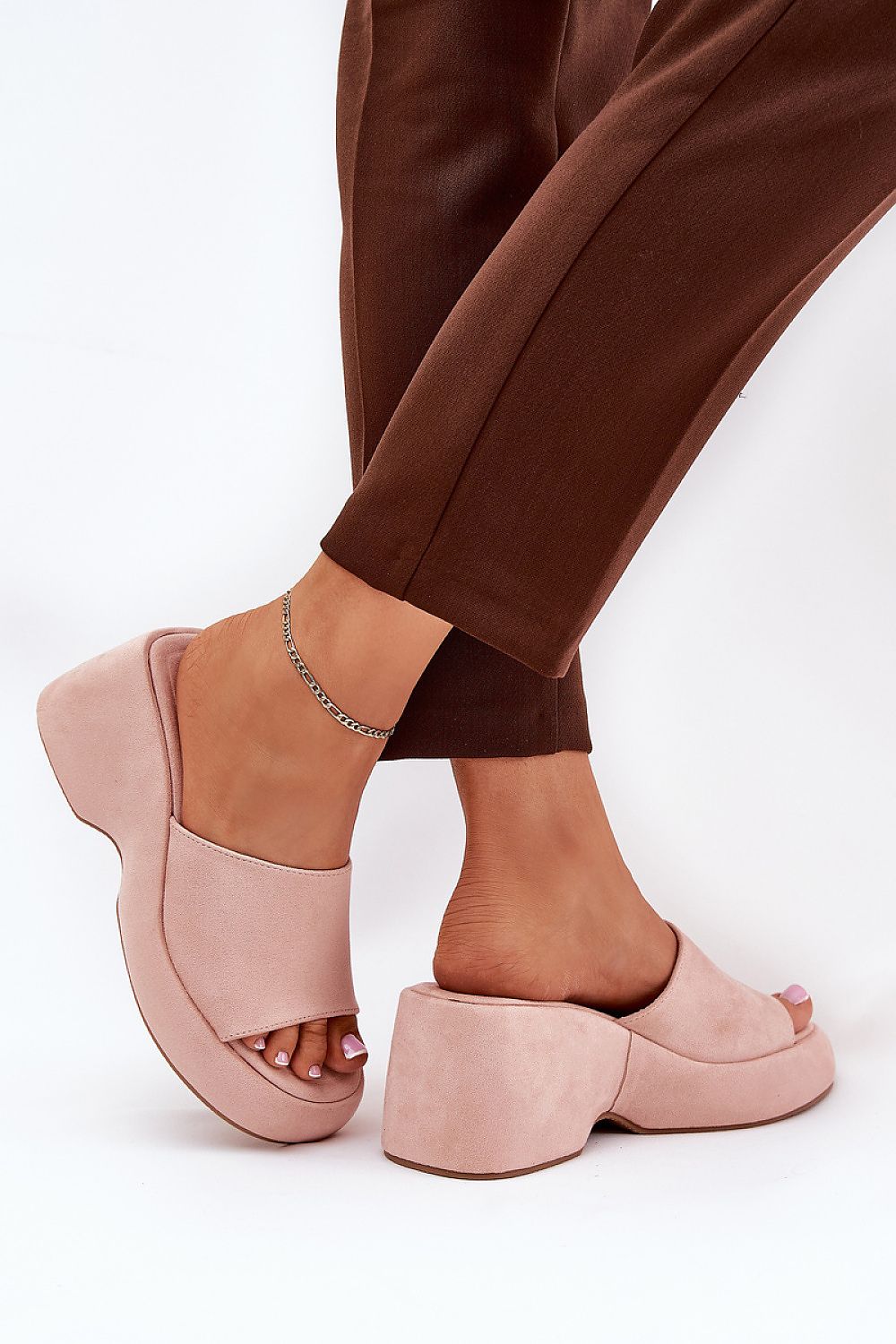 Open-toe wedge sandals with pink suede-like textile, elevated platform, and modern design, perfect for stylish summer outings.