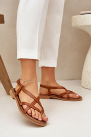 Erinelle interwoven leather sandals with delicate straps and ankle buckle, perfect for elegant summer wear, shown on a model's feet.