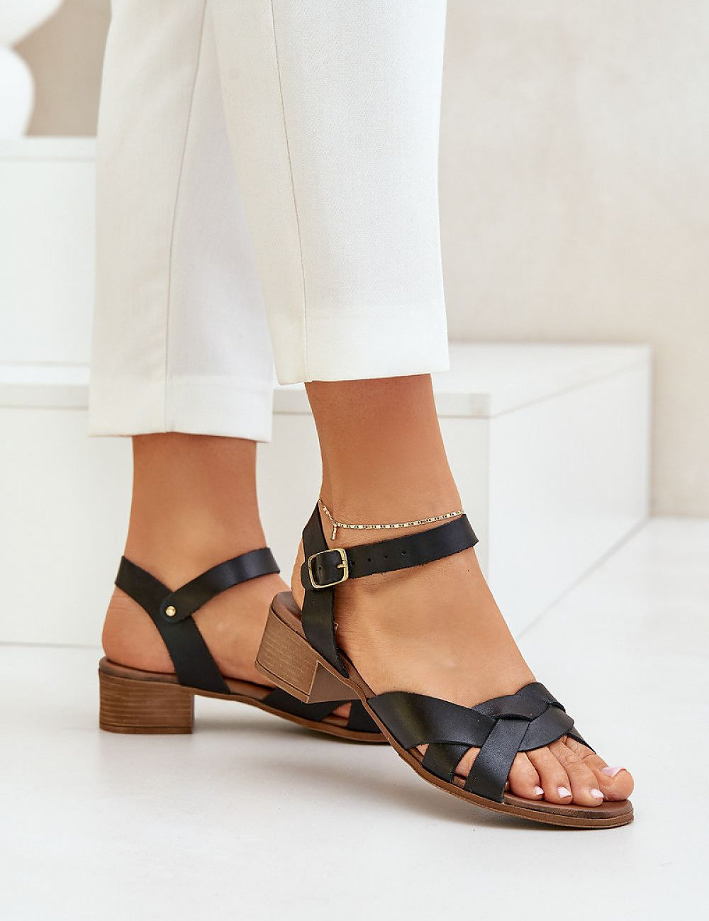 Valerinne cross-strap leather sandals with low block heel and adjustable ankle closure, ideal for summer elegance and comfort.