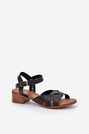Valerinne cross-strap leather sandals with low block heel and adjustable ankle closure.