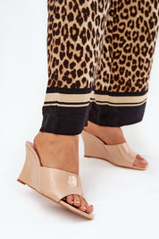 Model wearing Solena Slip-On Summer Clogs in eco leather with wedge heel, styled with leopard print trousers, showcasing open-toe design.