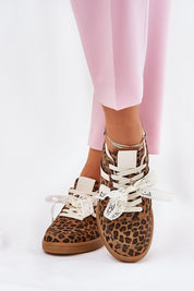 Model wearing Zyrmira Custom Lace Sport Sneakers with leopard print and lace accents, styled with pink pants.