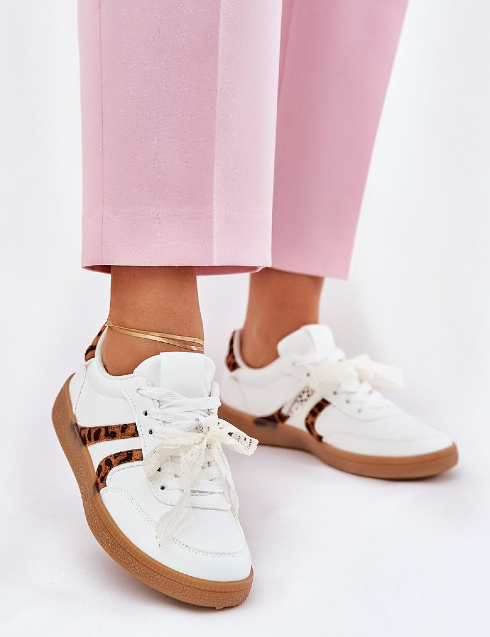 Person wearing Zyrmira Custom Lace Sport Sneakers with pink pants, showing eco leather and detachable lace accent for personalized style.