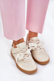 Woman wearing Zyrmira Custom Lace Sport Sneakers with pink pants, showcasing eco leather material and detachable lace detail.